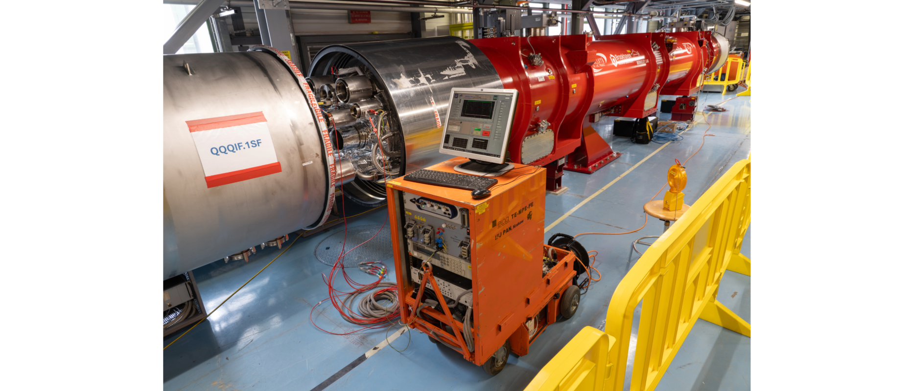 red cylindrical magnet with laptop in front of it