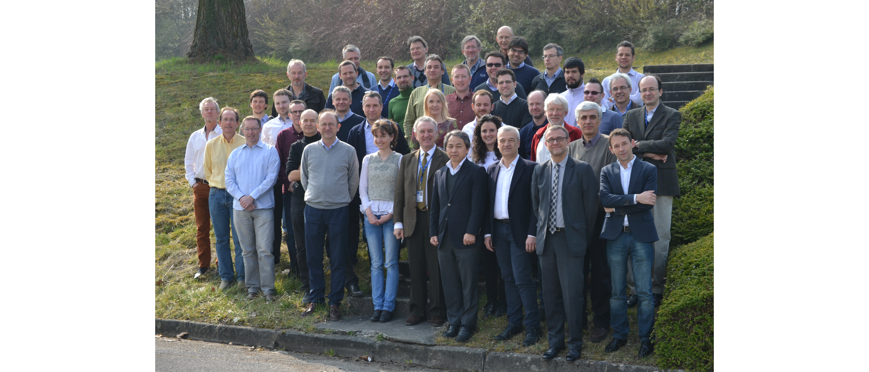 group photo of people standing on some grass