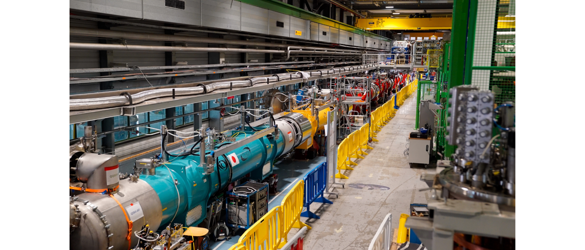 teal, yellow and red cylindrical magnets in line with snake-like equipment above