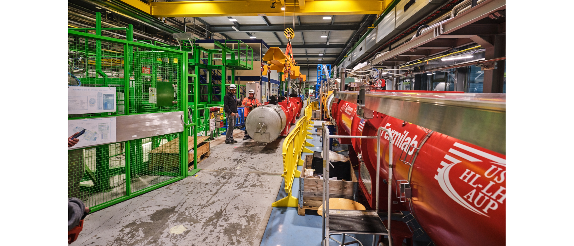 two red magnets, one lifted by crane