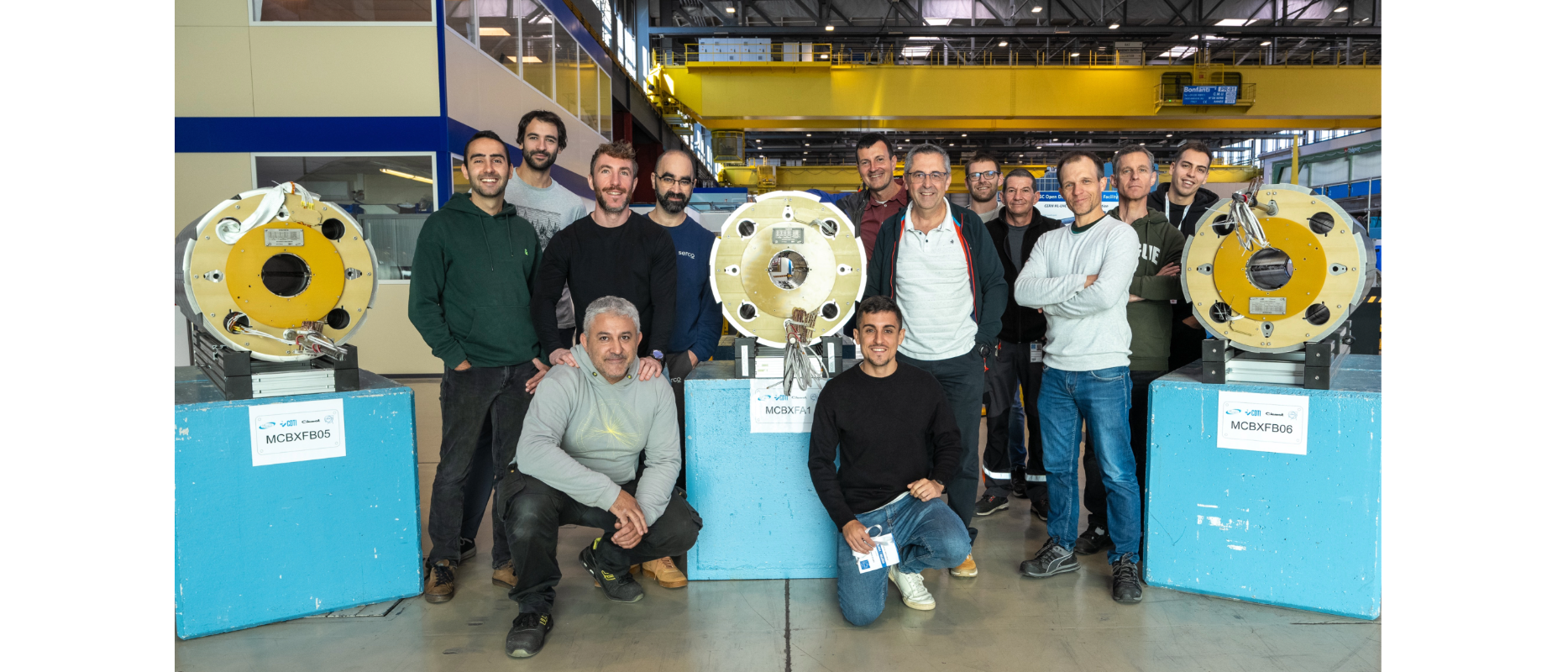 people smiling around cross-sections of magnets