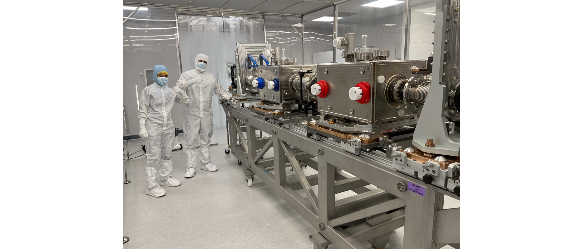 people in white protective suits with equipment