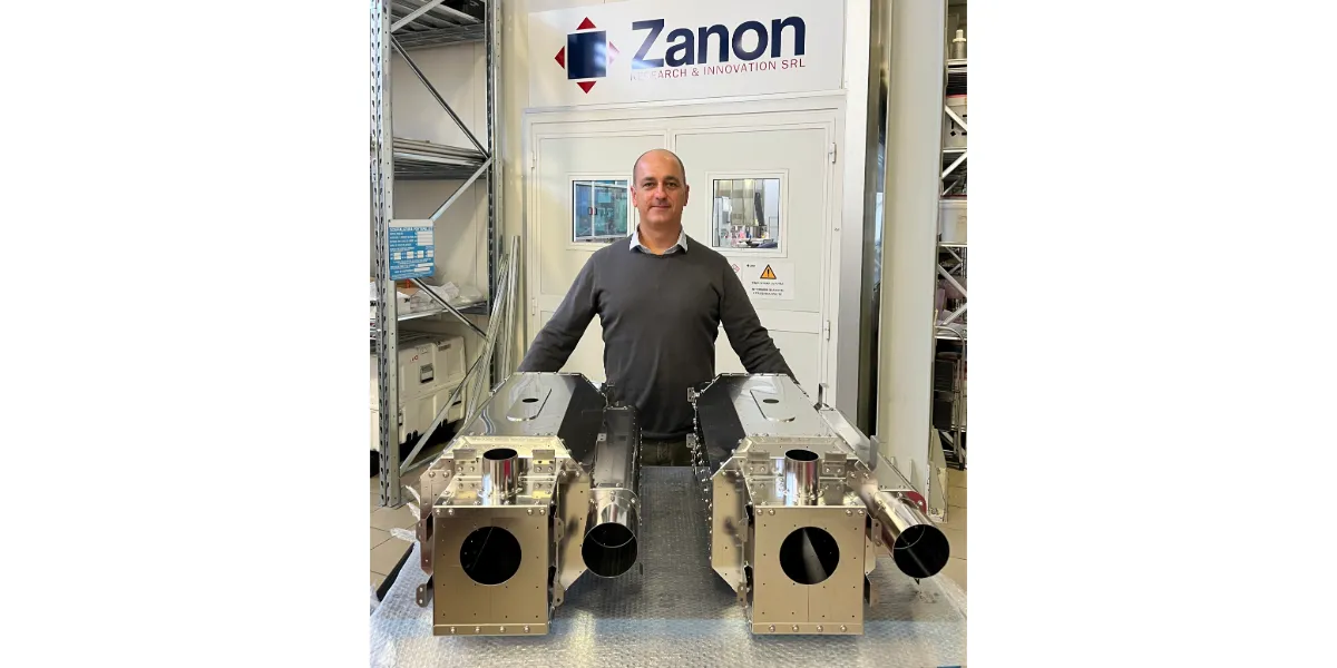 man standing with magnetic shields and helium tank materials in front of Zanon logo